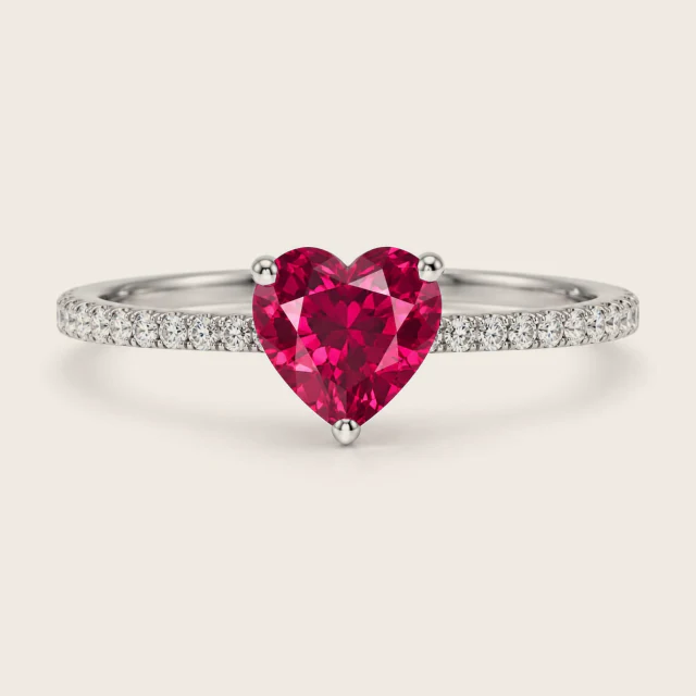 A heart cut centre stone in three prongs on a paved band