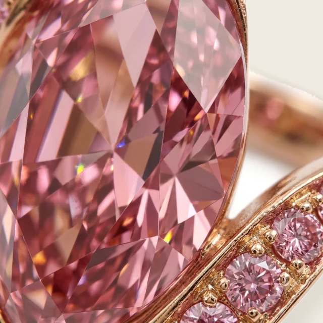 Close view into the facets of the marquise diamond, pink toned